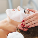 lady enjoying a facial massage and mask treatment