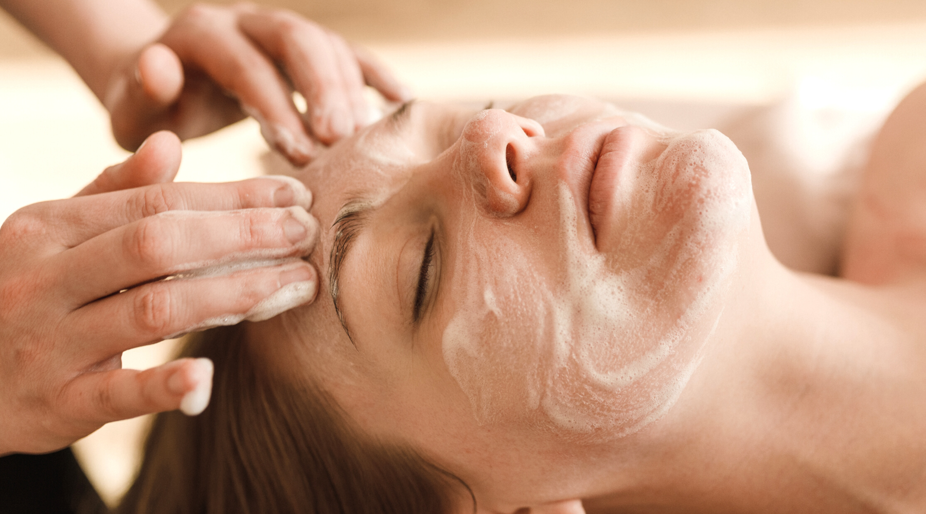 Relaxing Signature Custom Facial. Woman receiving a facial massage.